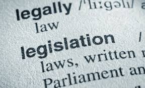 Close-up of a dictionary page highlighting the words "legislation," "legally," and their definitions.