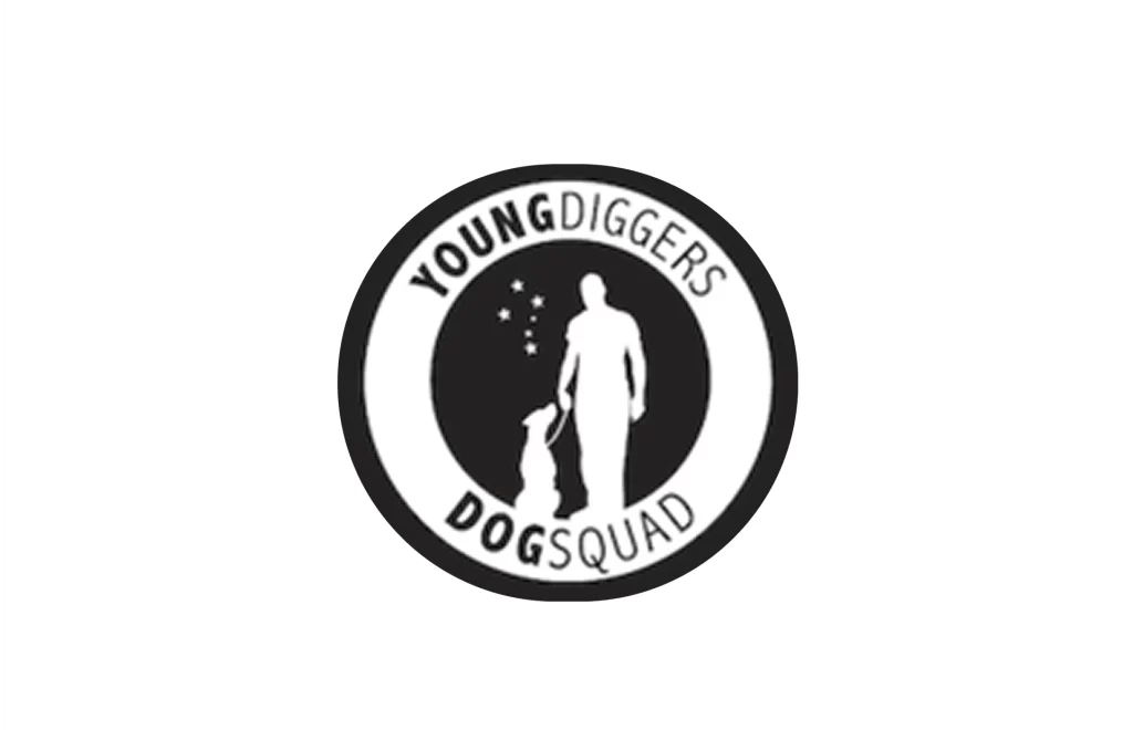 Circular logo with the text "YOUNG DIGGERS DOG SQUAD" around a silhouette of a person and a dog standing side by side, with stars above the dog.